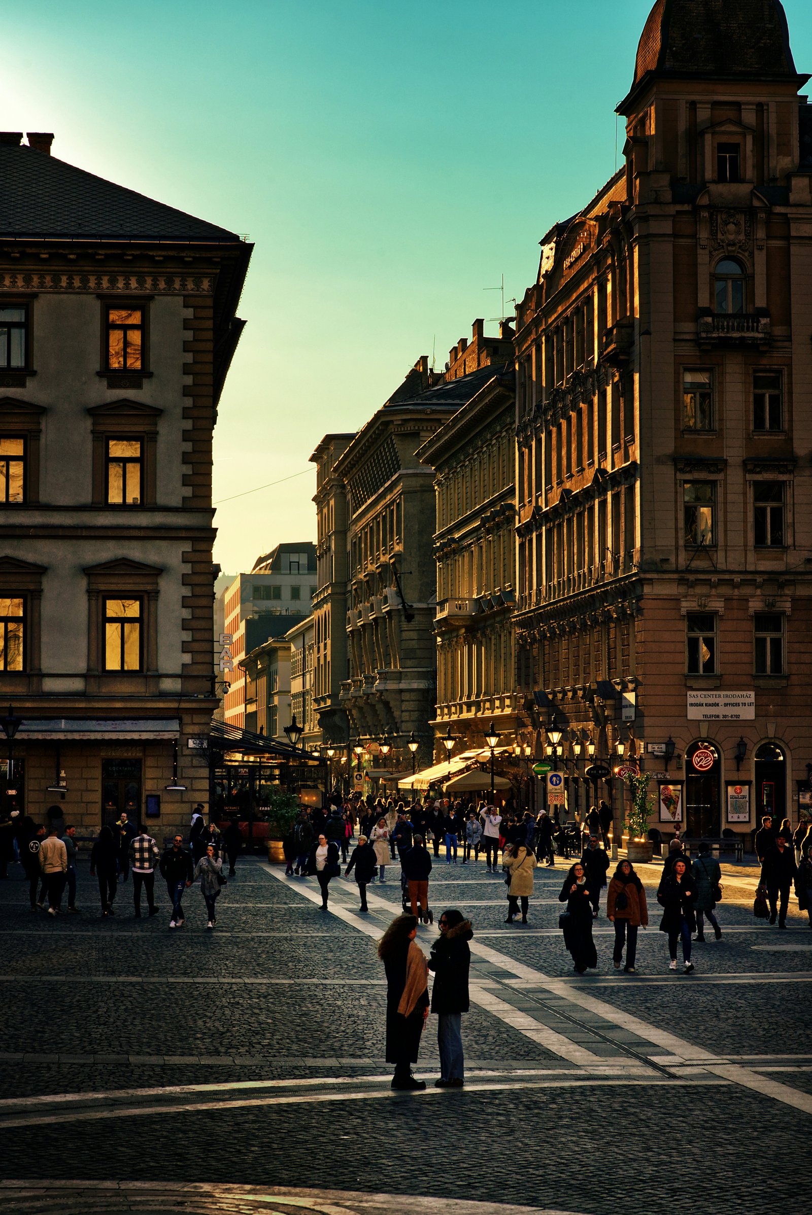 Aranyórás belvárosi tér emberekkel